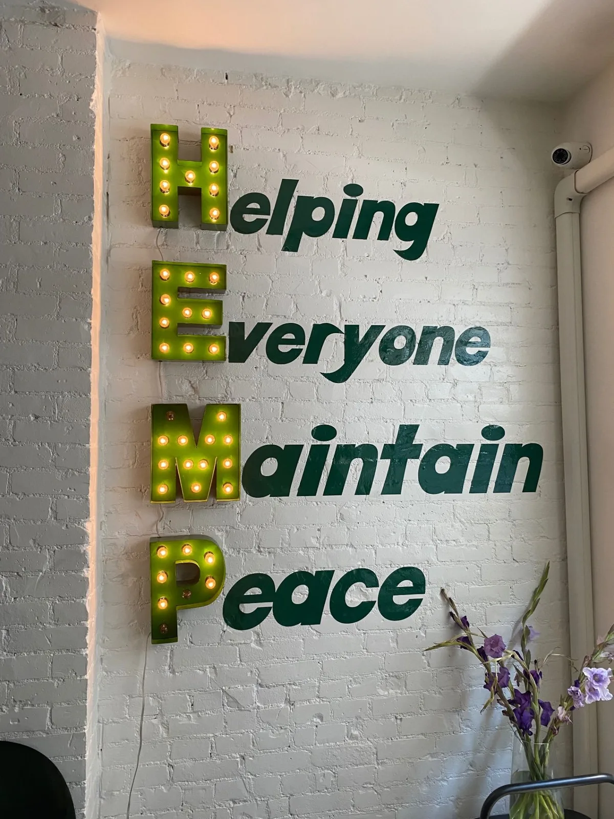 Helping Everyone Maintain Peace wall sign in a bright Plantivia interior